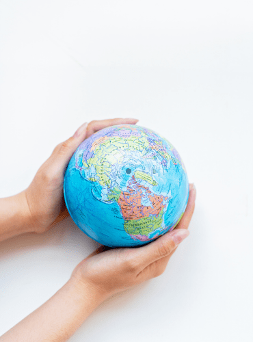 Hand holding a world representation.