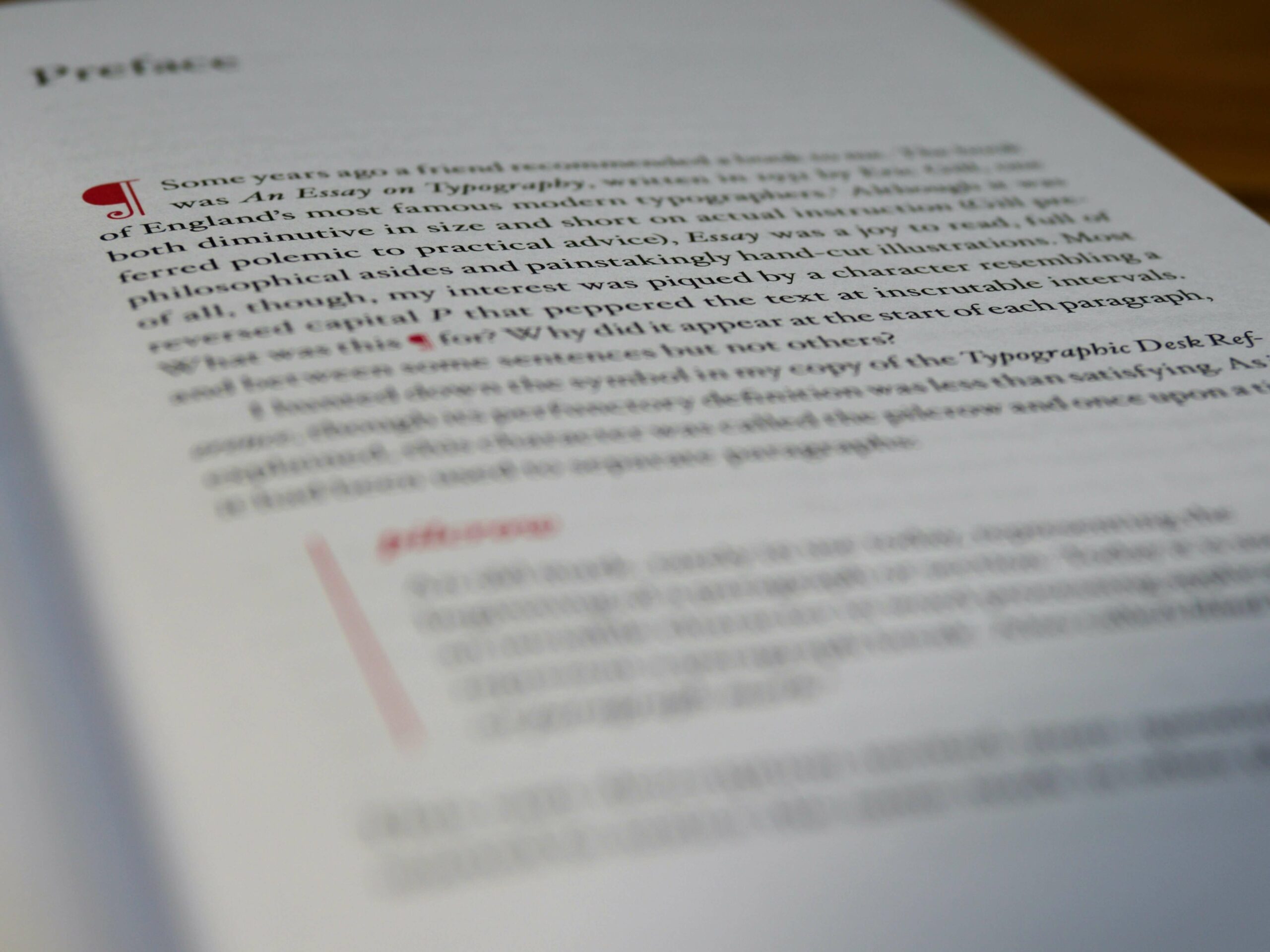 A book written in English is being copy edited: red notes and comments appear on the text.