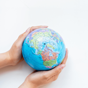 Hand holding a world representation.